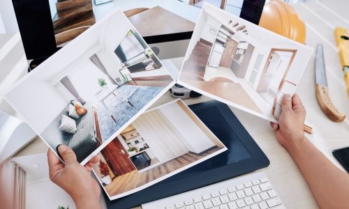 Interior designer looking at rooms photos and thinking how to refresh house of client